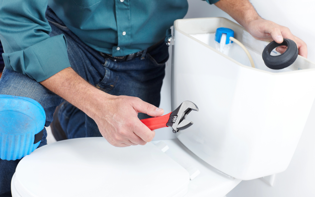 plumber working on toilet tank