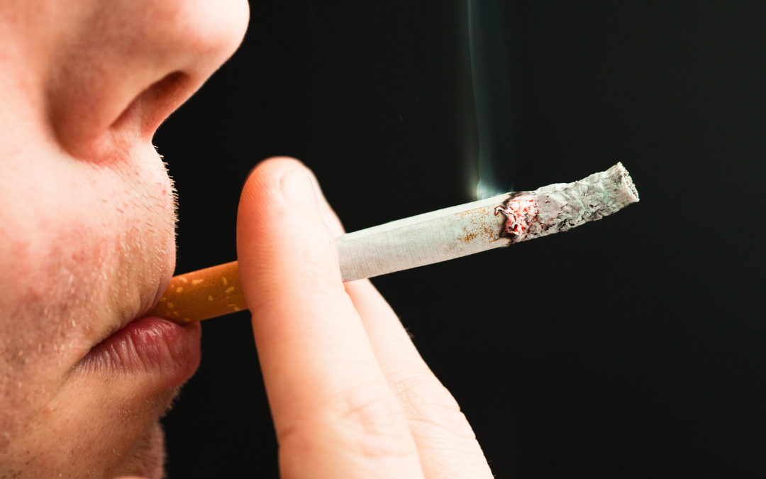 Smoker Has to Close Door : closeup of smoker with lit cigarette