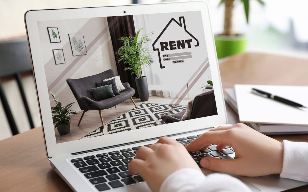 Apartment Building vs. Condo Rental - closeup of laptop woman is using to search rentals