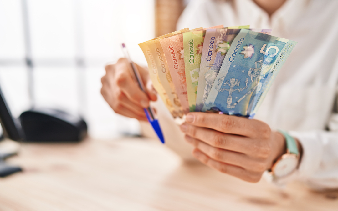 Fund Times - Why the condo corp is asking you to cough up more cash - image of woman at desk holding cash