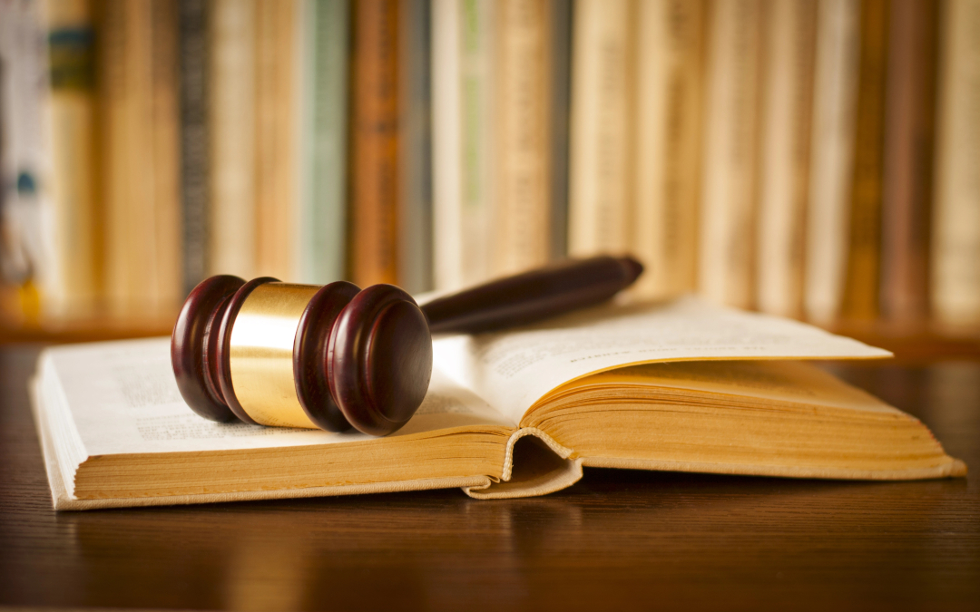 Standardized Laws May Clear Things Up - gavel resting on lawbook bookshelves in background